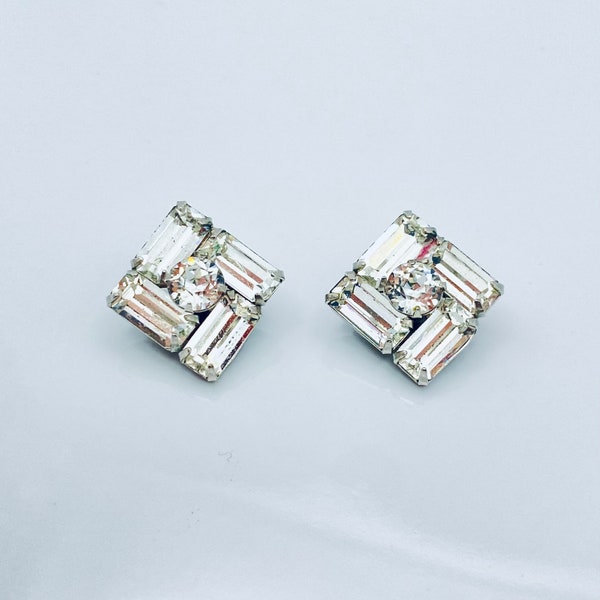 Vintage clear crystal diamond shape clip earrings. Round cut clear crystal with frame of 4 emerald cut crystals.