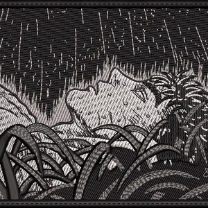 May include: A black and white embroidered patch depicting a person lying in tall grass with rain falling. The person's face is visible and they appear to be looking up at the sky.