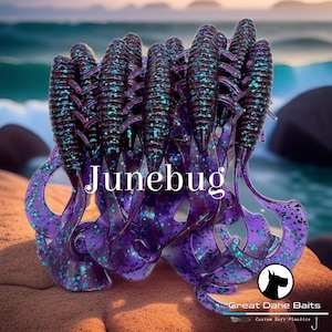 May include: A cluster of soft plastic fishing lures in shades of purple and dark brown, with iridescent blue glitter. The word "Junebug" is displayed in white text. The lures are designed with a segmented body and a curly tail.