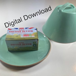 May include: A teal ceramic butter dish with a matching lid and a package of salted British butter on a teal plate. The butter package features the Union Jack flag and the words "Salted British Butter". The words "Digital Download" are in the background.