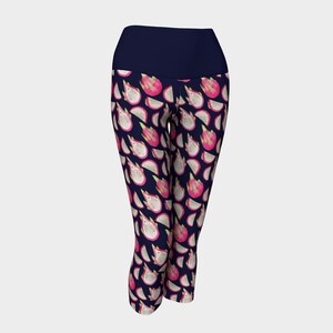 May include: Navy blue cropped leggings with a white and pink dragon fruit print.