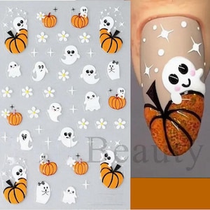May include: A sheet of Halloween nail stickers with images of pumpkins, ghosts, and flowers. The stickers are white and orange and are designed to be applied to fingernails.