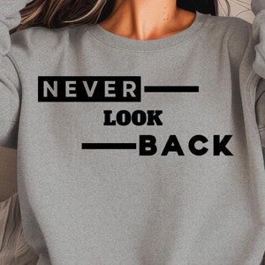 Inspirational Soft Style Apparel | Never Look Back T-Shirts & Sweaters | Comfortable Motivational Tops for Men and Women | Gift-Ready!