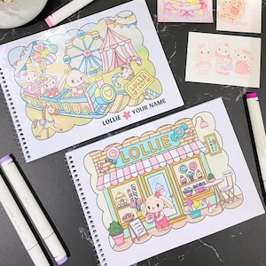 May include: Two spiral-bound colouring books featuring pastel illustrations of a bunny character in a candy shop and a carnival setting. The covers include the text Lollie Land and Lollie, with a space for a name, alongside markers and small cards.