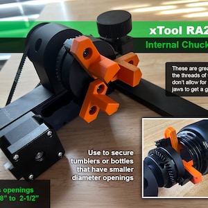 May include: A black xTool RA2 Pro internal chuck jaws tool with orange plastic jaws. The tool is used to secure tumblers or bottles that have smaller diameter openings. The text "Supports openings from 1-5/8" to 2-1/2"" is visible on the bottom left of the image. The text "xTool RA2 Pro Internal Chuck Jaws" is visible on the top right of the image. The text "These are great for when the threads of the opening don't allow for the chuck jaws to get a good grip" is visible on the right side of the image.