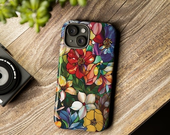 May include: A colourful phone case with a floral design. The case features a variety of flowers in shades of red, yellow, blue, and green. The flowers are arranged in a stained glass style.