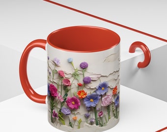 May include: A red and white ceramic mug with a floral design. The mug features a variety of colourful flowers, including pink, purple, blue, and yellow. The flowers are arranged in a cluster on a white background.