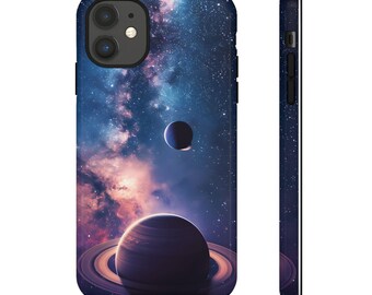 May include: A phone case featuring a galaxy and planets design. The case has a dark blue background with a swirling galaxy of stars and a large planet with rings in the foreground. There is a smaller planet in the background.