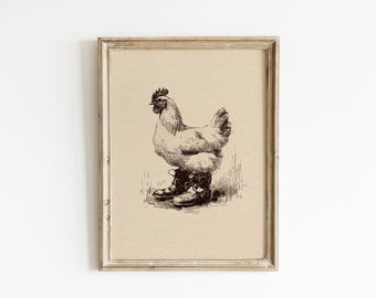 May include: A framed print with a vintage aesthetic, depicting a chicken in boots. The pen and ink illustration is set against a beige backdrop, with the chicken standing in grass. The frame is made of light, distressed wood.