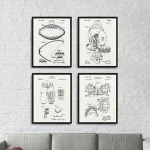 May include: Four black and white framed prints of vintage football equipment patent drawings. The prints feature drawings of a football, a helmet, and two different types of football pants.