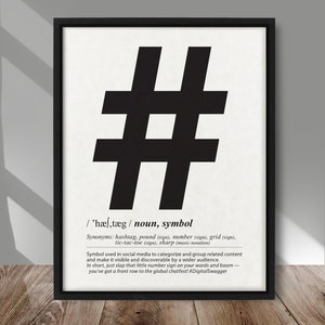May include: Black and white graphic design print of the hashtag symbol with a definition of the word hashtag. The definition explains that the hashtag is used in social media to categorise and group related content.