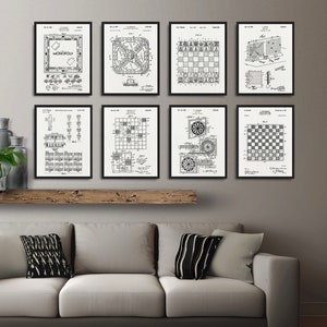 May include: A set of eight black and white framed prints of vintage game board patent drawings. The prints feature drawings of Monopoly, checkers, chess, and other classic games.
