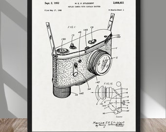 May include: A black and white line drawing of a reflex camera with a curtain shutter. The drawing is from a patent filed in 1948 by Maurice E.P. Studdert. The patent number is 2,608,921. The drawing shows the camera from the top and side views. The camera has a lens, a viewfinder, and a shutter.