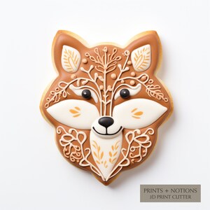 May include: A brown gingerbread cookie decorated with white and yellow icing in the shape of a fox's face. The cookie has intricate details and a whimsical design.