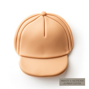 May include: A tan-colored 3D printed baseball cap with a flat brim. The cap is designed to be used with a 3D print cutter.