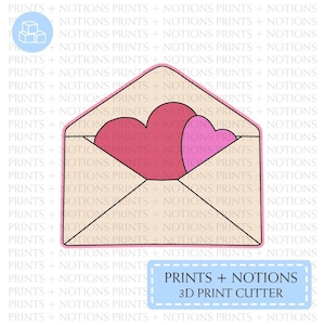 May include: A 3D printable design for a love letter envelope with two hearts inside. The envelope is beige with a black outline. The hearts are pink and red. The text "PRINTS + NOTIONS 3D PRINT CUTTER" is in a blue box.