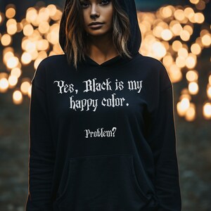 May include: Black hoodie with the text "Yes, Black is my happy colour. Problem?" in white lettering.