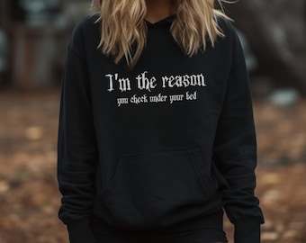 May include: Black hooded sweatshirt with the text "I'm the reason you check under your bed" in white gothic font.