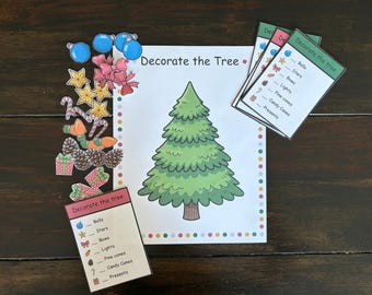 May include: A Christmas-themed activity set with a large green tree illustration and the text "Decorate the Tree." Includes cutouts of ornaments, stars, bows, lights, pine cones, candy canes, and presents.