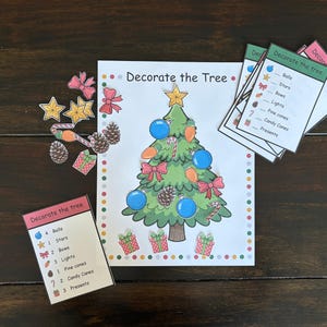 May include: A Christmas-themed activity set with a decorated tree illustration, ornaments, and cards. The set includes a green Christmas tree with blue balls, red bows, and candy canes. Additional cutouts include stars, bows, pine cones, and gift boxes.