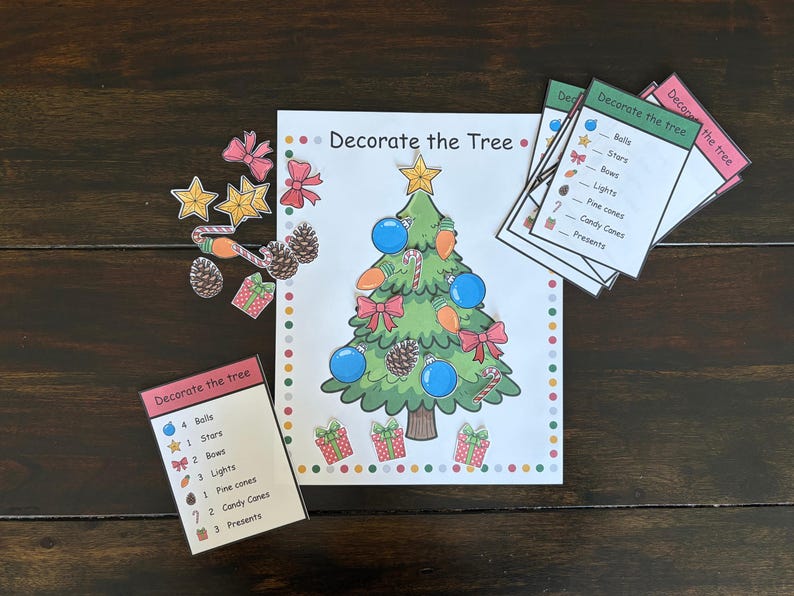 May include: A Christmas-themed activity set with a decorated tree illustration, ornaments, and cards. The set includes a green Christmas tree with blue balls, red bows, and candy canes. Additional cutouts include stars, bows, pine cones, and gift boxes.