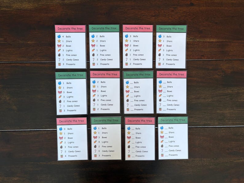 May include: Twelve small cards with the text "Decorate the tree" at the top. Each card has a list of Christmas-themed items like bells, stars, bows, lights, pine cones, candy canes, and presents.