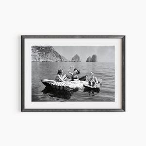 a black and white photo of three people in a boat