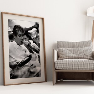 a framed photograph of a tennis player next to a chair