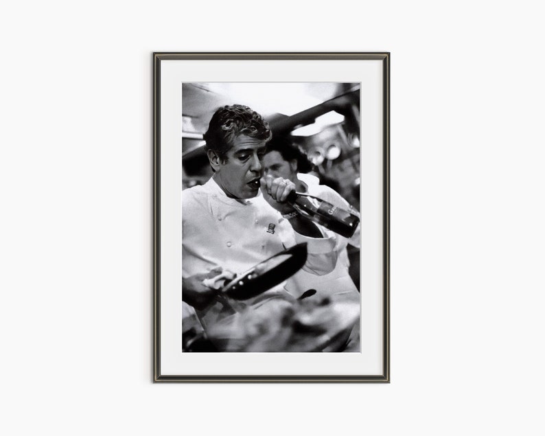 a black and white photo of a man holding a bottle of wine