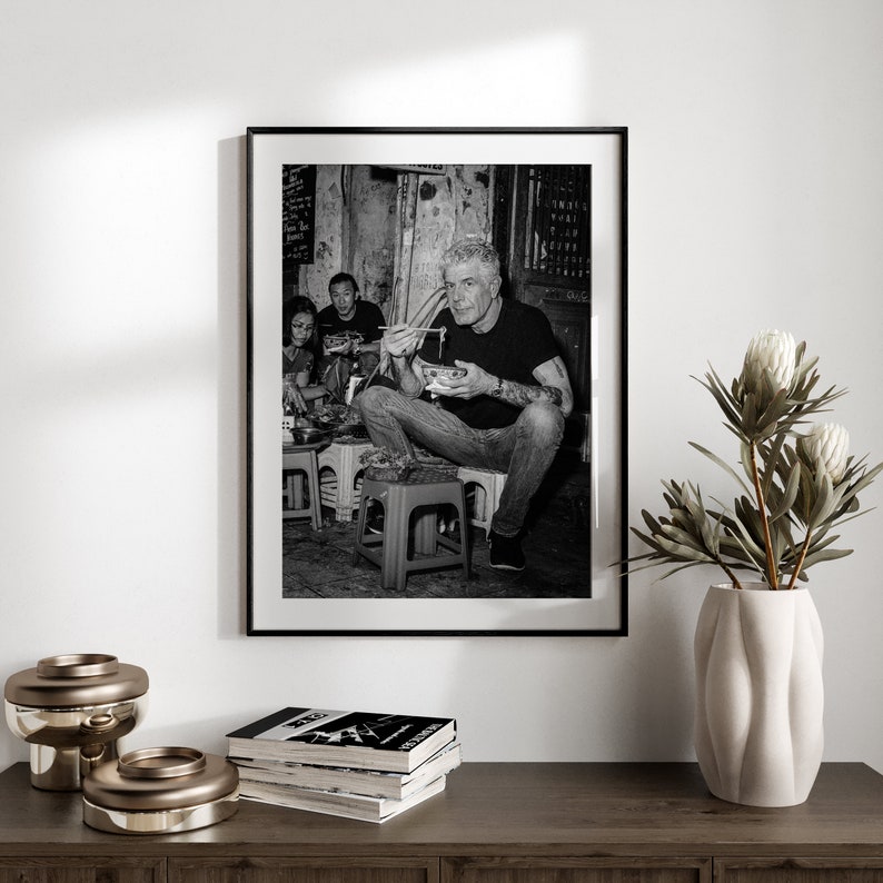 a black and white photo of a man sitting in a chair