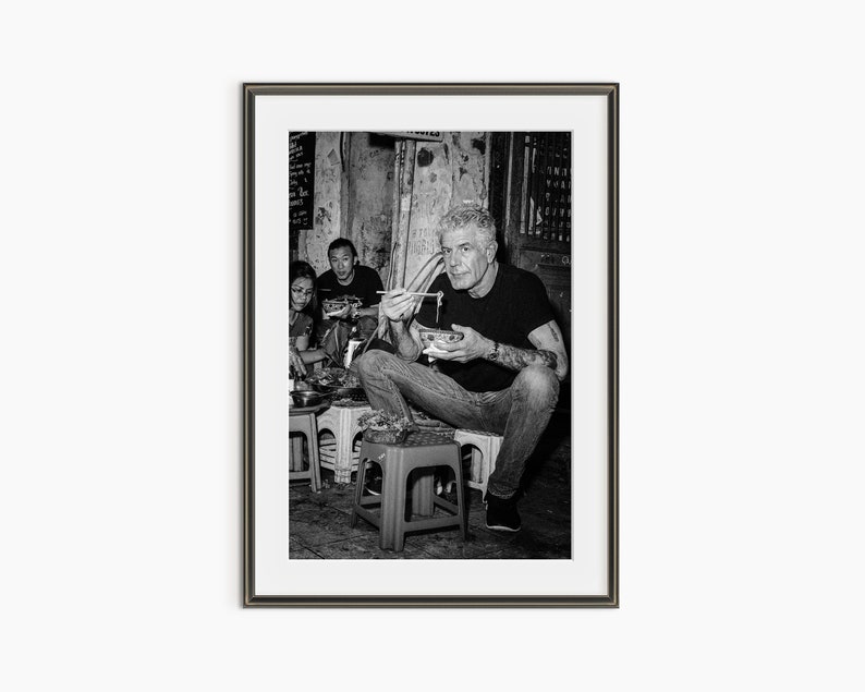 a black and white photo of a man playing a guitar