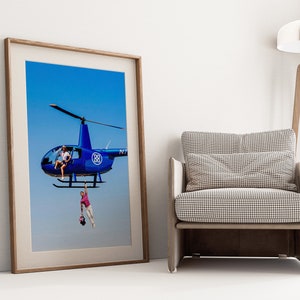 a picture of a helicopter hanging on a wall next to a chair