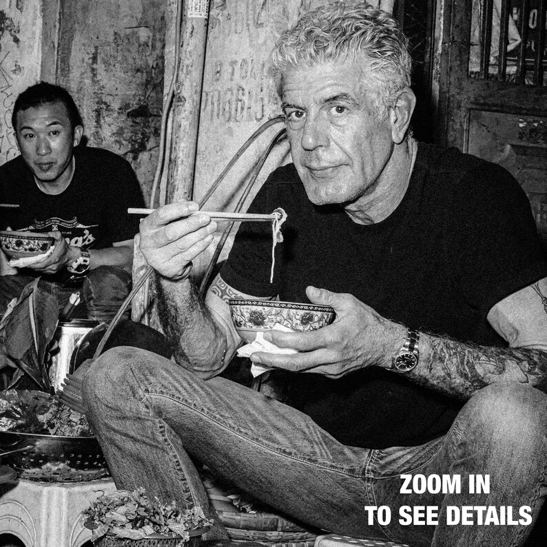 a man eating a bowl of noodles with chopsticks