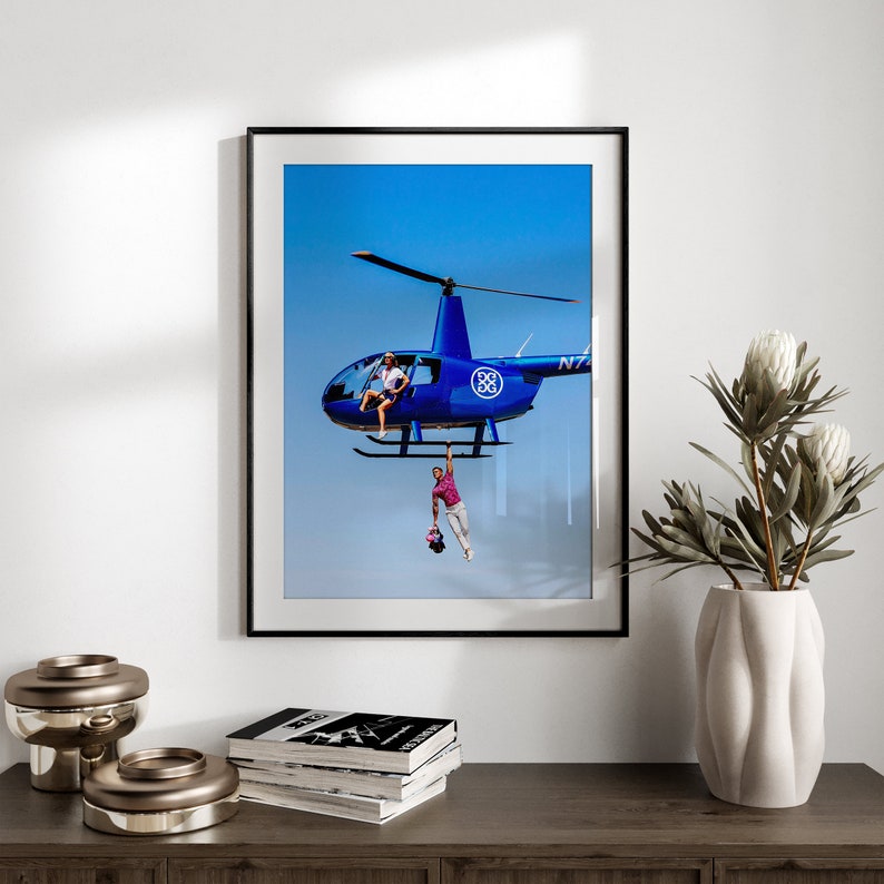 a picture of a blue helicopter hanging on a wall