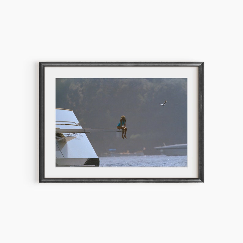 a picture of a person on a boat in the water