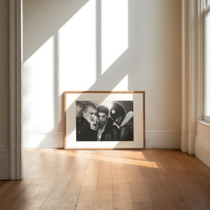 a framed photograph of two people in a room