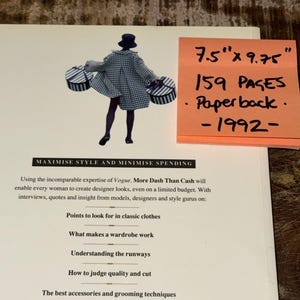 May include: A book cover with a black and white illustration of a woman carrying two boxes. The book title is "Maximise Style and Minimise Spending". The book cover also includes the text "More Dash Than Cash" and "Using the incomparable expertise of Vogue". The book cover also includes a sticky note with the text "7.5" x 9.75", "159 Pages", "Paperback", and "1992".