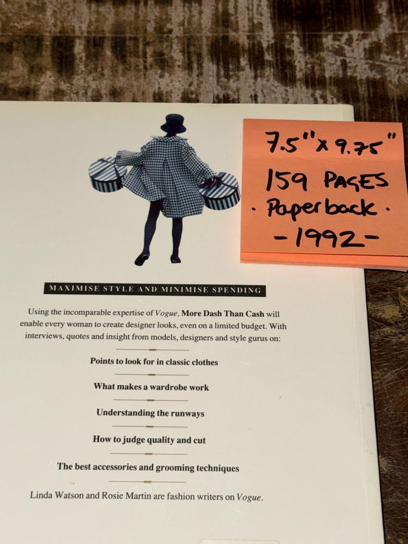 May include: A book cover with a black and white illustration of a woman carrying two boxes. The book title is "Maximise Style and Minimise Spending". The book cover also includes the text "More Dash Than Cash" and "Using the incomparable expertise of Vogue". The book cover also includes a sticky note with the text "7.5" x 9.75", "159 Pages", "Paperback", and "1992".