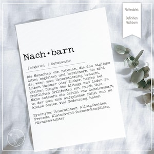 May include: A white card featuring the German word "Nachbarn" (Neighbors) in black, with a definition and synonyms. A small banner in the top right corner says "Definition Nachbarn". The card is on a white surface.
