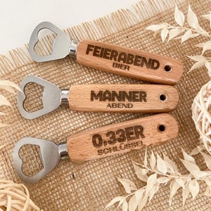 May include: Three wooden bottle openers with engraved text. The top opener says "Feierabend Bier", the middle opener says "M&auml;nner Abend", and the bottom opener says "0.33er Schl&uuml;ssel".