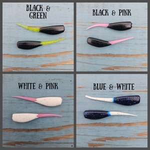 May include: Four different color combinations of soft plastic fishing lures. The lures are black and green, black and pink, white and pink, and blue and white.