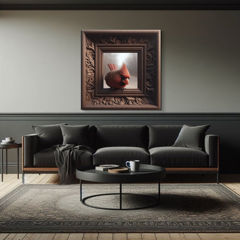 May include: A red cardinal bird perched on a branch inside a dark wood frame with ornate carvings. The frame is hanging on a gray wall above a black sofa.