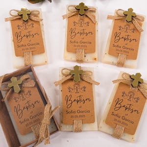 These beautiful handmade scented soap favors are a thoughtful gift for your special occasion. Ideal for baptisms, confirmations, christenings, first holy communions, quinceanera, sweet 16 or religious celebrations, each soap comes with a kraft paper tag customized with your guest of honor’s name, event date, and a personal message.

Each favor is topped with a rustic jute twine bow and a delicate charm, creating a charming and elegant presentation. Soaps are available in various scent-colors.