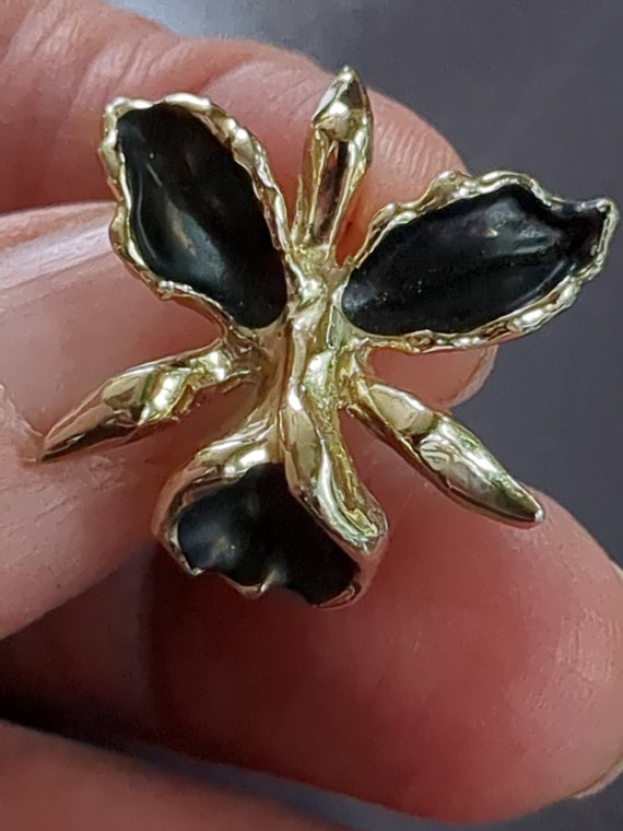 Tiny twin black and gold flower pins