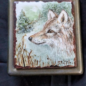 Hand painted fox or coyote china plack on belt buckle.