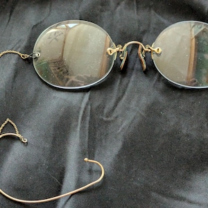 Pince-Nez rimless glasses, sunglasses, and bifocals with chain and ear hook from the turn of the centry.