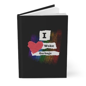 May include: Black journal with the text "I ❤️ Woke Garbage" in a distressed font. The design includes a red heart and a rainbow-colored background, creating a bold and eye-catching statement.