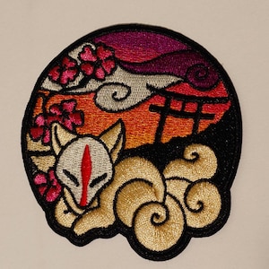 Peut inclure: Patch brodé représentant un renard blanc avec une bande rouge sur le visage, enroulé dans une forme nuageuse. L'arrière-plan est une scène de coucher de soleil avec des fleurs de cerisier roses, une porte torii et un ciel violet.