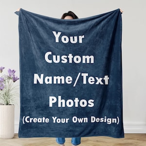May include: A navy blue blanket with white text that reads "Your Custom Name/Text Photos (Create Your Own Design)". The blanket is held up by a person. The blanket has a soft, velvety texture.