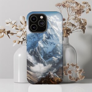 May include: A phone case with a photo of a snow-capped mountain range. The case is black and has a camera cutout.